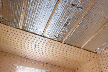 Image showing Stage of finishing clapboard ceiling in a country house