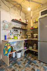 Image showing A temporary kitchen made of planks and shelves in a renovated room