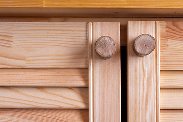 Image showing wooden homemade handles on the wooden facades of the kitchen set