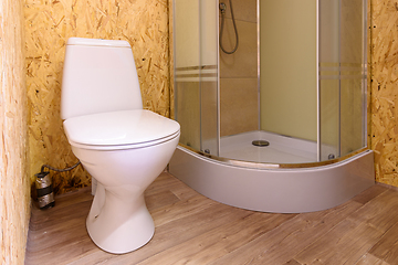 Image showing Bathroom in a wooden house, toilet and shower