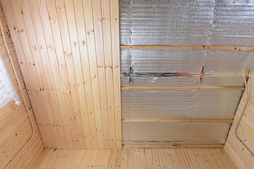 Image showing Partially finished ceiling with clapboard in the room of a wooden house