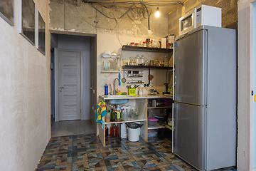 Image showing The interior of the living room combined with a kitchen without renovation with a temporary kitchen set