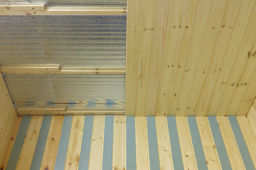 Image showing finishing with wooden clapboard ceiling in the room of a country house