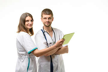 Image showing Two doctors discuss the test results and looked at the frame