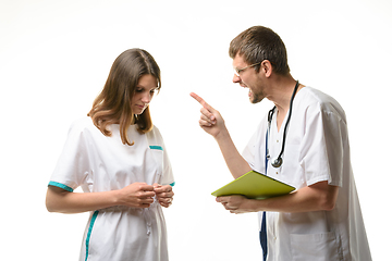 Image showing The doctor yells at the intern for an error in the patient\'s record