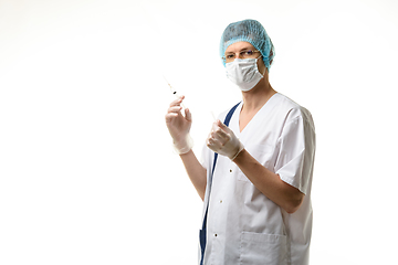 Image showing Surgeon holds a syringe in his hands and looked into the frame, isolated on white background