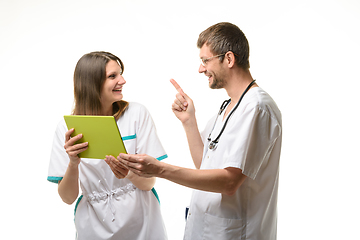 Image showing Two doctors have fun discussing information on a tablet
