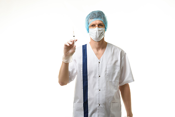 Image showing Surgeon holding a syringe in his hands and looking into the frame, isolated on white background