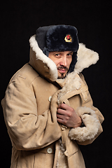 Image showing Portrait of a frozen man of Caucasian appearance in a Soviet officer\'s fur hat and an army sheepskin coat