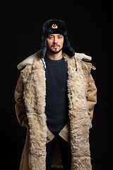 Image showing Portrait of a confident man of Caucasian appearance in a Soviet officer fur hat and army sheepskin coat