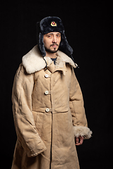 Image showing Portrait of a man of Caucasian appearance in a Soviet officer\'s fur hat and army sheepskin coat