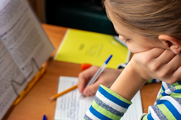 Image showing Close-up of a girl doing homework