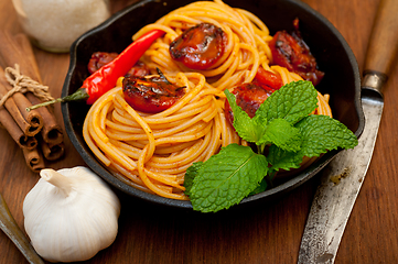 Image showing italian spaghetti pasta and tomato with mint leaves 