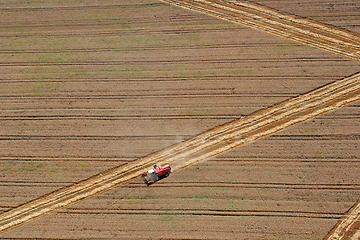 Image showing Combine harvester working in the fields