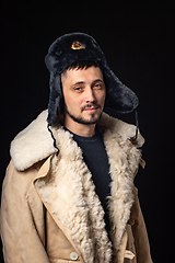 Image showing Portrait of a man of thirty years of Caucasian appearance in a Soviet officer\'s fur hat and an army sheepskin coat