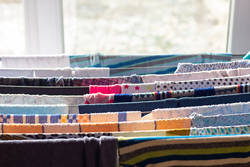 Image showing Laundry is dried in a dryer near the window