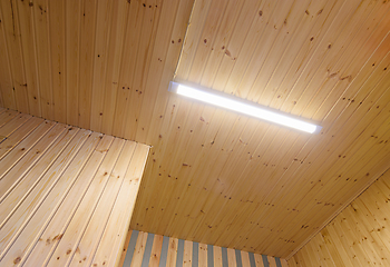 Image showing View of a ceiling from a wooden lining with an included LED daylight lamp