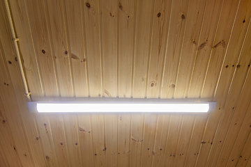 Image showing Long LED lamp on wood paneling ceiling