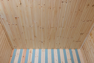 Image showing Part of the ceiling and walls finished with wooden lining in a small country room