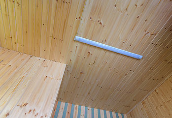 Image showing View of a ceiling made of wood clapboard with fixed length LED daylight lamp