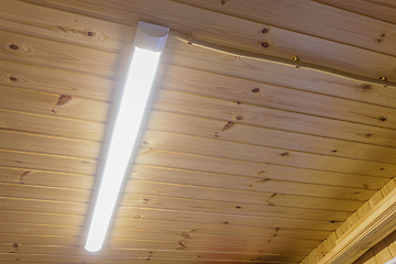 Image showing Included daylight lamp on wood paneling ceiling