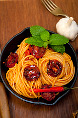 Image showing italian spaghetti pasta and tomato with mint leaves 