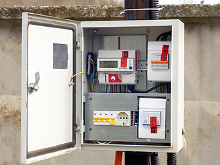 Image showing Introductory machine and electric energy meter in a dashboard on a pole on a land plot