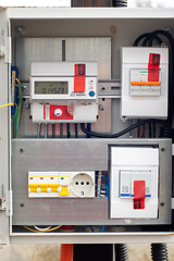 Image showing An introductory machine and an electric energy meter in a dashboard on a pole close-up