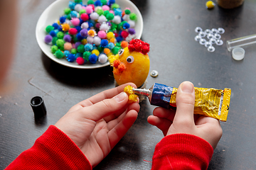 Image showing Child\'s hands make a chicken-shaped egg shell craft