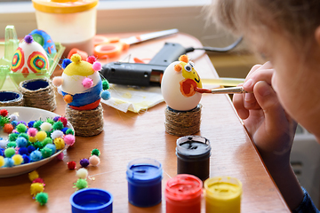 Image showing Girl carefully and neatly paints Easter eggs, close-up