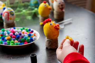 Image showing A child makes gifts with his own hands for Easter, a decorative element in the child\'s cancer