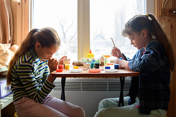 Image showing Children at home at the table make crafts and gifts for the holiday