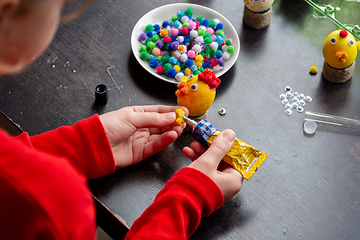 Image showing a girl in the workshop makes crafts from eggs for the Easter holiday