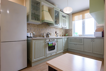 Image showing Interior of a modern classic kitchen with a corner kitchen set by the window