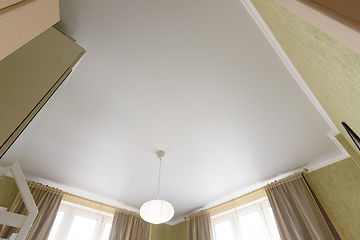 Image showing Stretch white matte ceiling close-up with a chandelier in the interior of a living bedroom