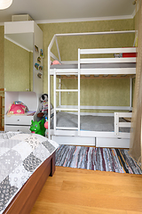 Image showing Fragment of the interior of a bedroom with a large double bed and a children\'s bunk bed