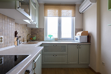 Image showing Fragment of a corner kitchen set in the interior of the kitchen with a large window