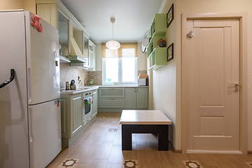 Image showing The interior of the living room combined with the kitchen, in the foreground is the door to the room