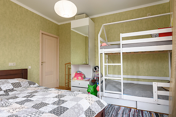 Image showing Bedroom interior with a large double bed and a children\'s bunk bed