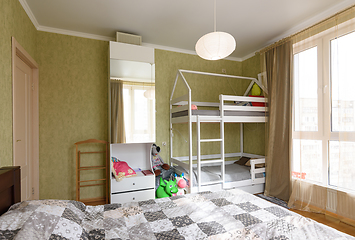 Image showing Interior of an adult bedroom, in the room there is a children\'s bunk bed