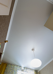 Image showing Stretch white matte ceiling with a chandelier in the interior of a rectangular room