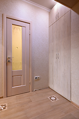 Image showing View of the door to the toilet room and a large wardrobe in the interior of the hallway