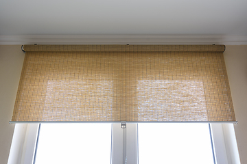 Image showing Roller blinds made of thin bamboo on the window