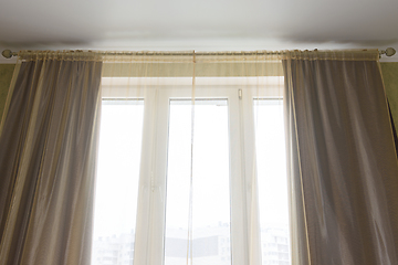 Image showing Curtains and tulle curtains large plastic windows in the apartment, close-up