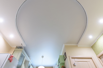 Image showing Two-level oval suspended ceiling in the interior of the living room, the lower level is made of plasterboard, the upper level is stretched from polyvinyl chloride