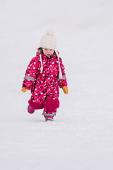 Image showing little girl having fun at snowy winter day