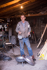 Image showing A blacksmith worker showing handmade products ready for sale