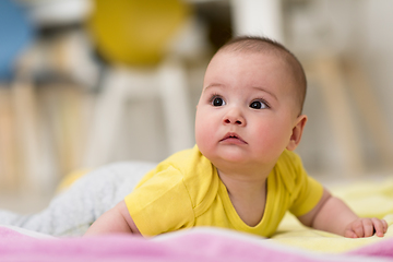 Image showing newborn baby boy playing on the floor