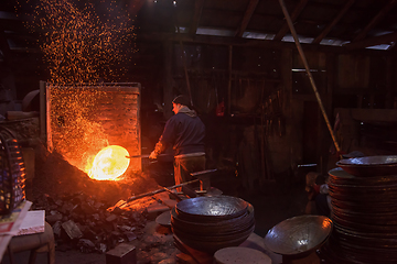 Image showing blacksmith workers using mechanical hammer at workshop