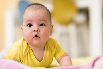 Image showing newborn baby boy playing on the floor